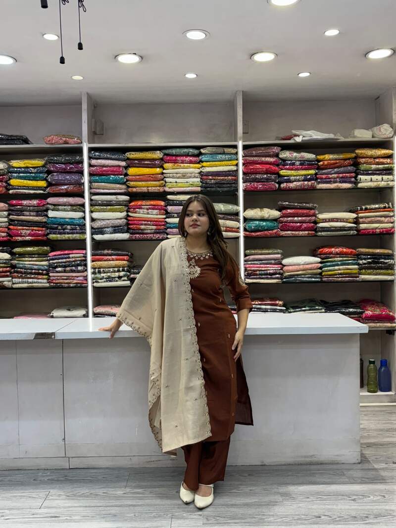 Customer wearing a rust brown embroidered kurti with cream dupatta at Radha Fashion